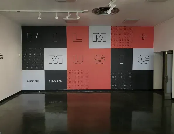 an empty room with a wall that says film music