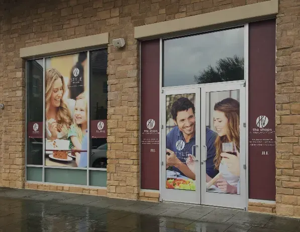 a building with a picture of a family on the windows