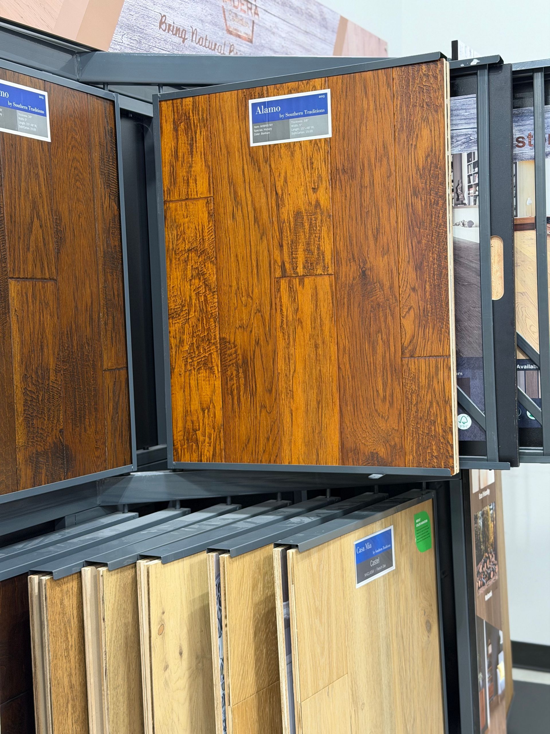 Wood-grain sample panels in a metal display rack, showing brown and tan finish options.