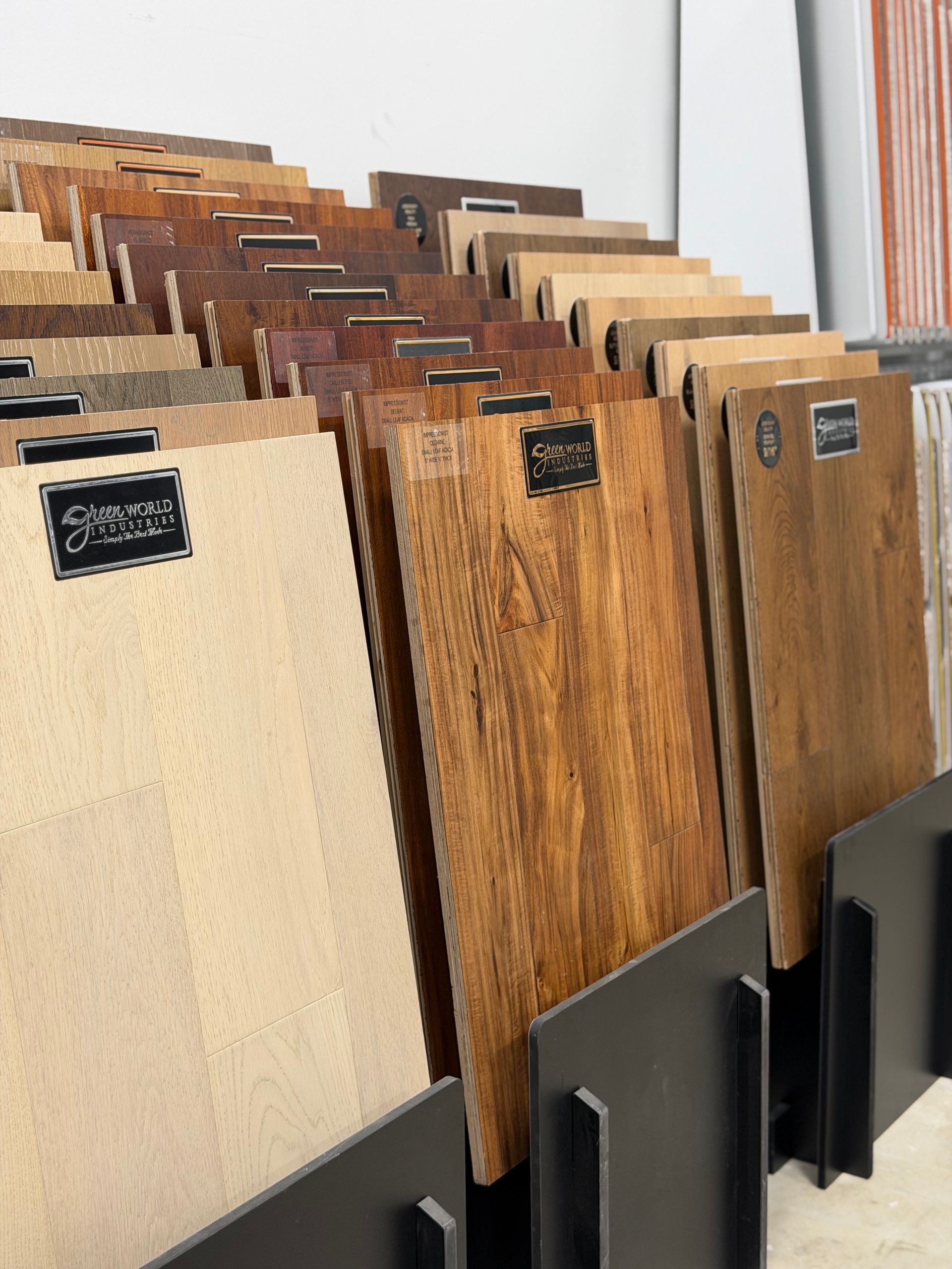 Wood sample display rack with assorted beige, brown, and woodgrain panels stacked vertically