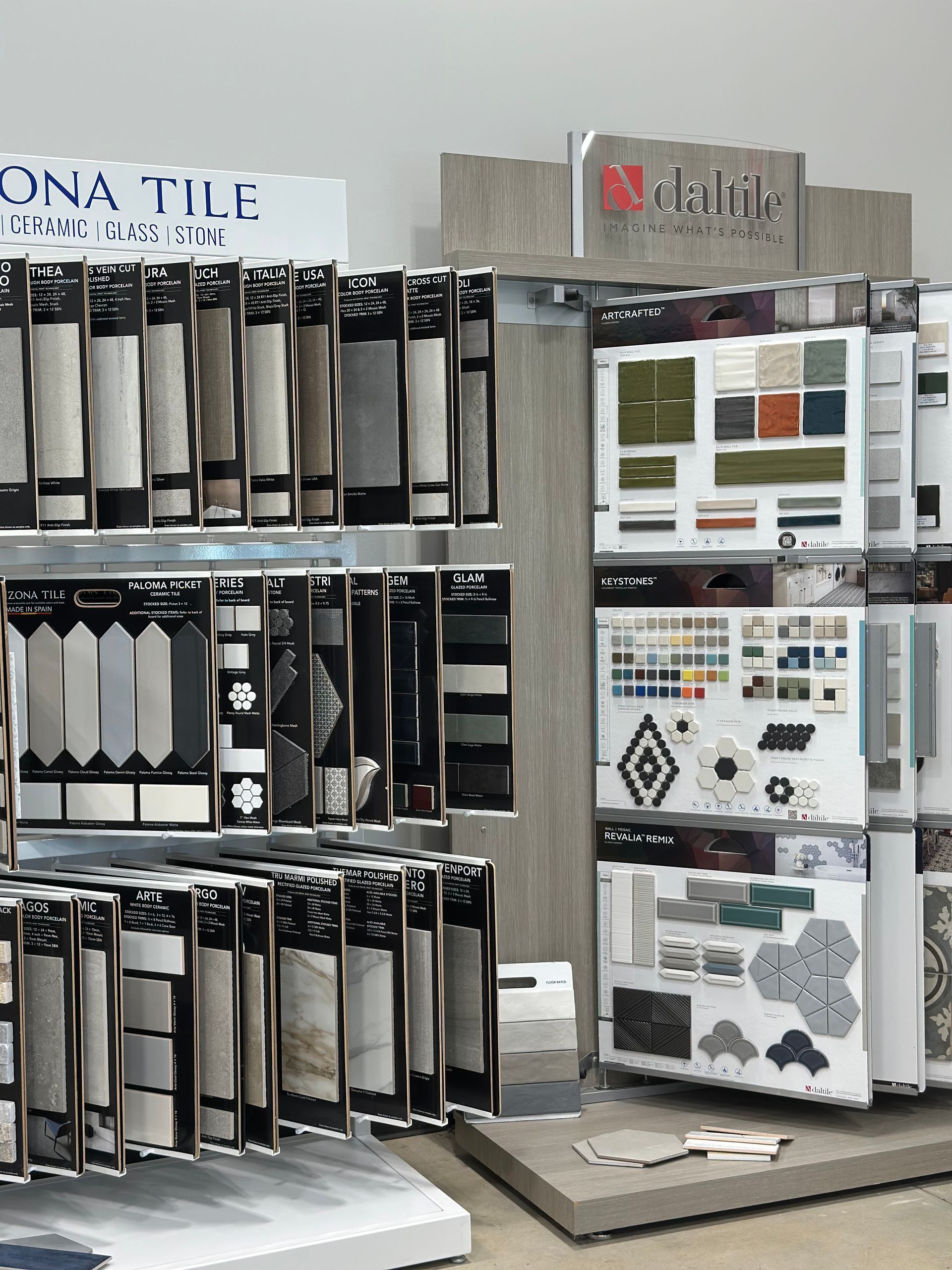 Tile showroom display with hanging sample boards and a wall of color and pattern samples