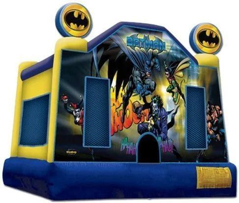 Batman-themed inflatable bounce house. Features Batman, Robin, and Joker. Blue, yellow, and black colors.