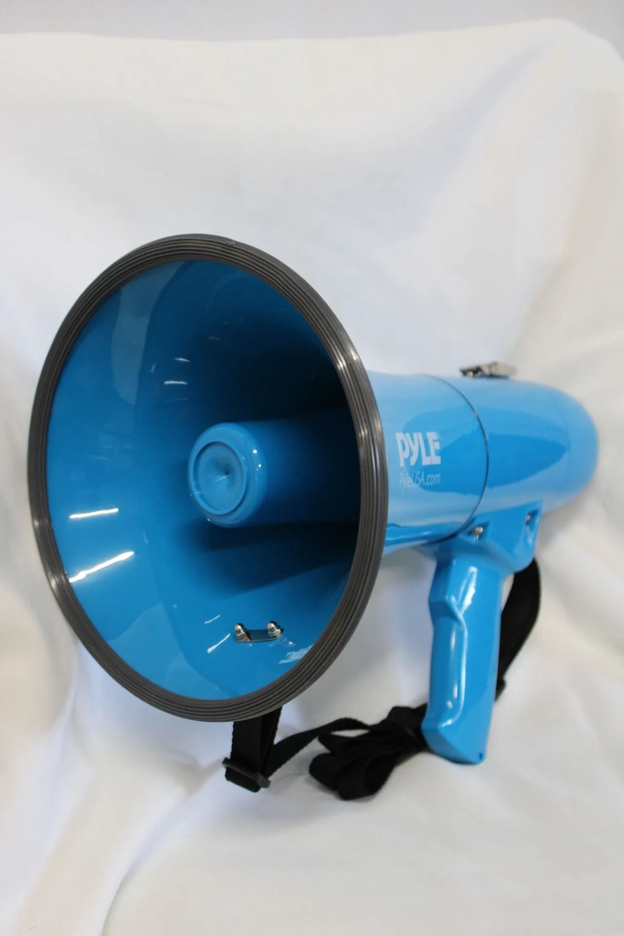 Blue megaphone with black trim and a black strap, white background.