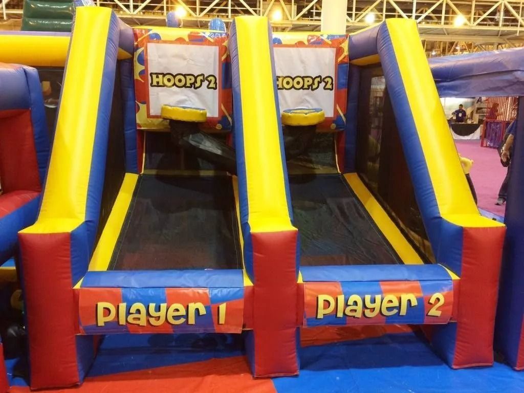 Inflatable basketball hoop game for two players, red, yellow, and blue. Players shoot for hoops labeled "Hoops 1" and "Hoops 2."