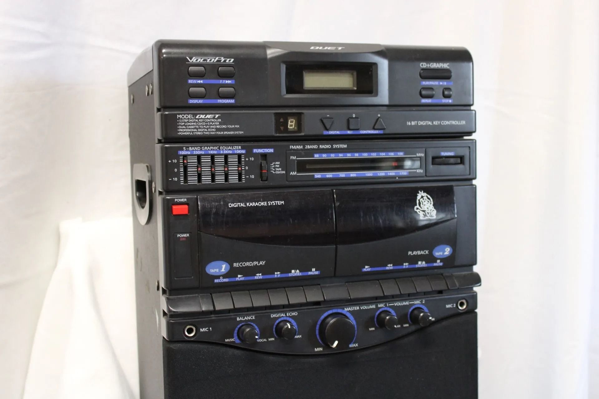 Black stereo system with multiple components stacked vertically.