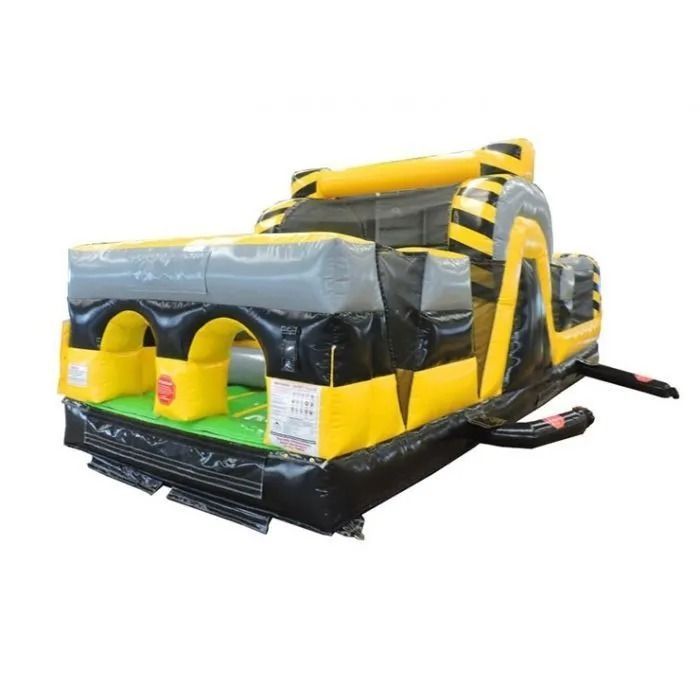 Inflatable obstacle course with yellow, gray, and black sections; arches, climbing wall, and slides.