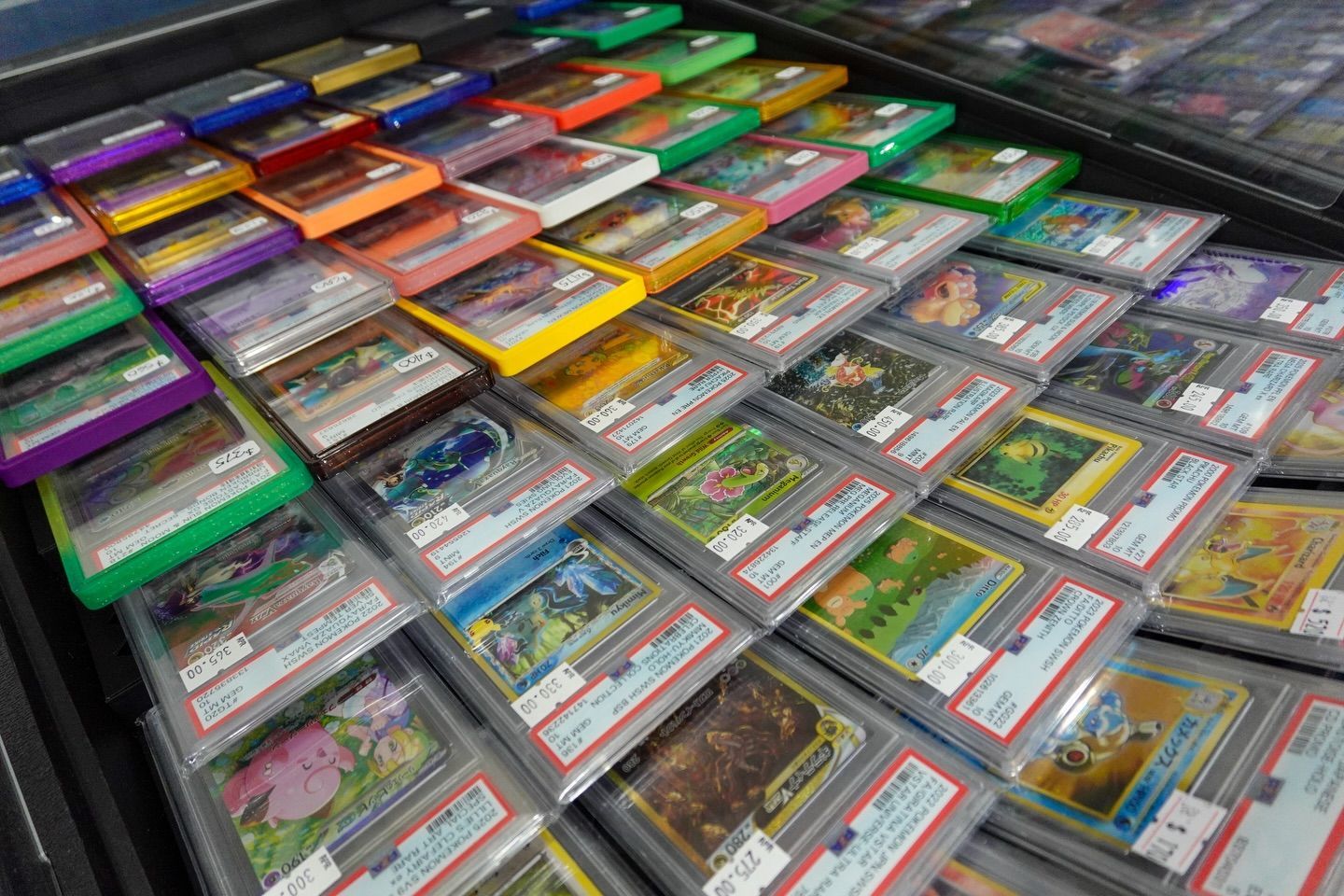 Rows of colorful video game cartridges in plastic cases displayed on a table