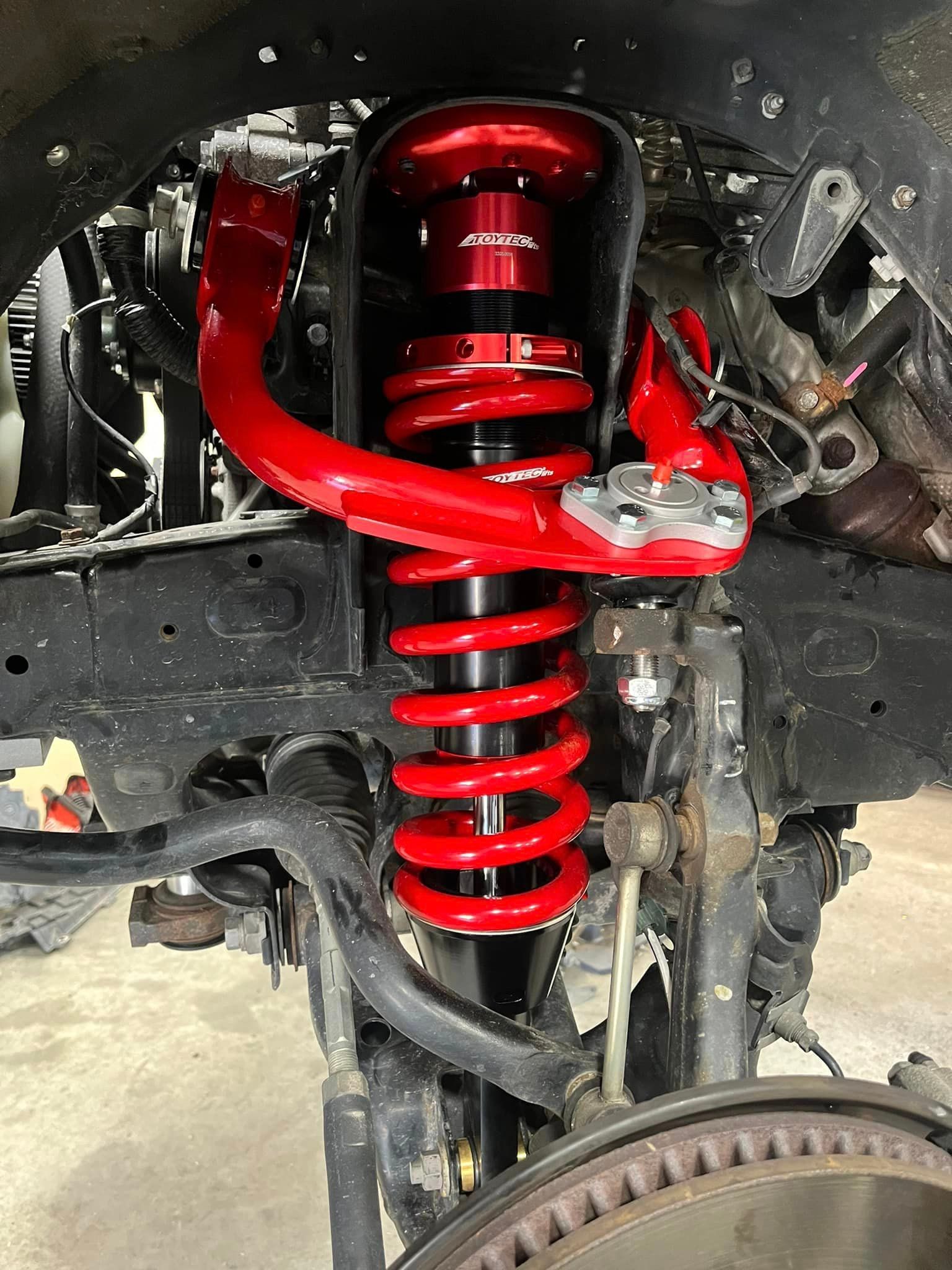 a close up of a red shock absorber on a car