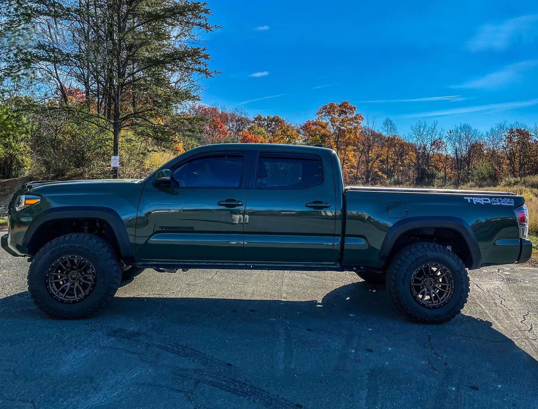 parked pickup truck with the woods in the background