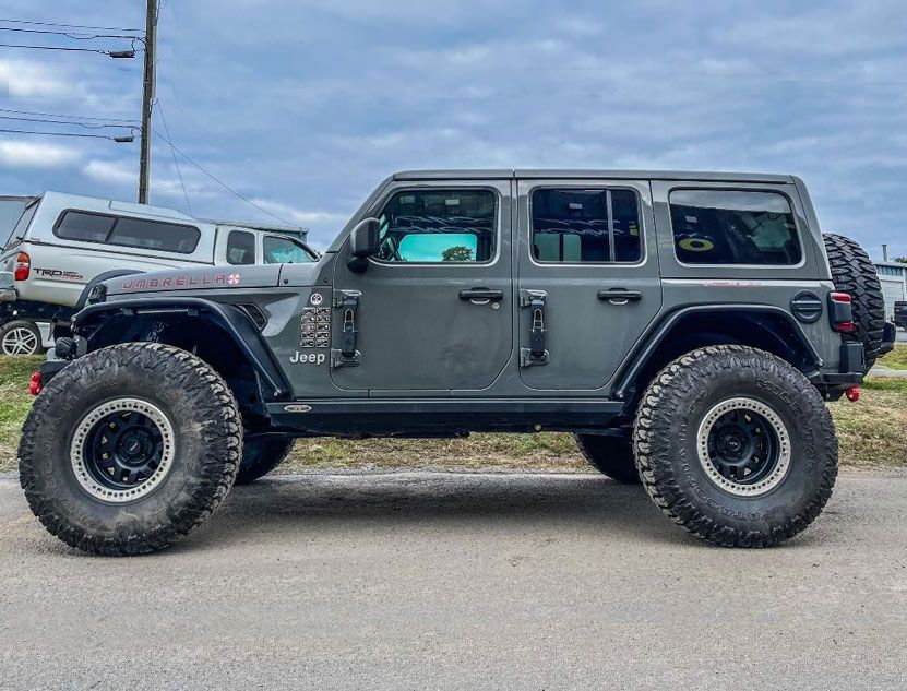 Gray Jeep outside garage
