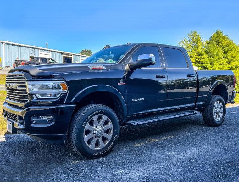 black RAM outside garage