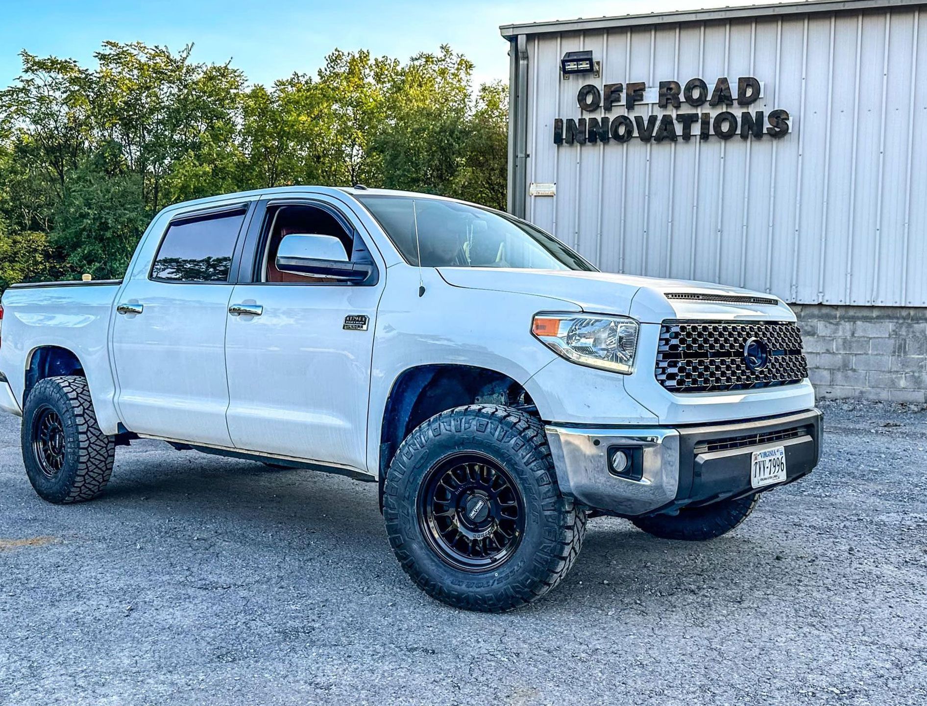 white ford outside garage