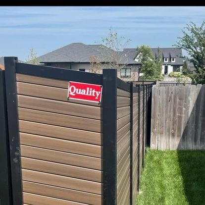 Brown and black wooden fence with a 