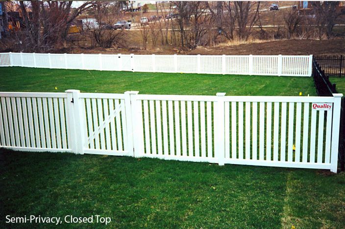 White semi-privacy fence with closed top, enclosing a grassy backyard.