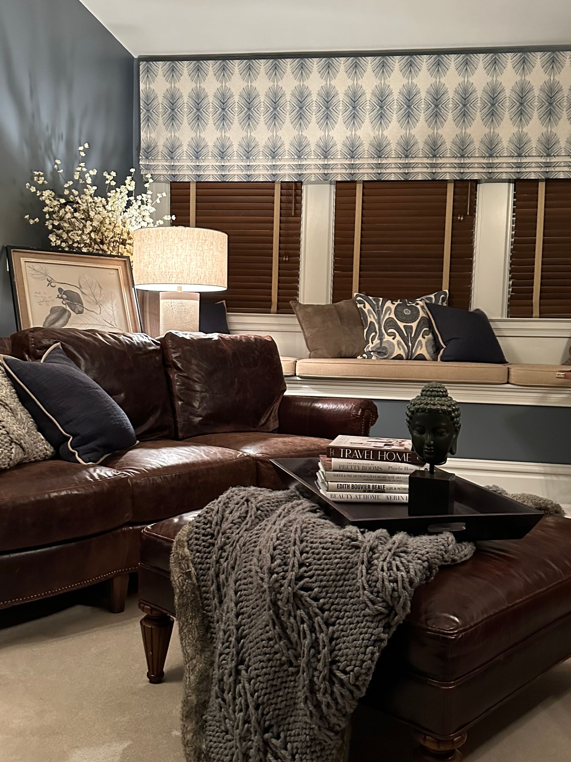 A living room with a chair, dresser, and mirror.