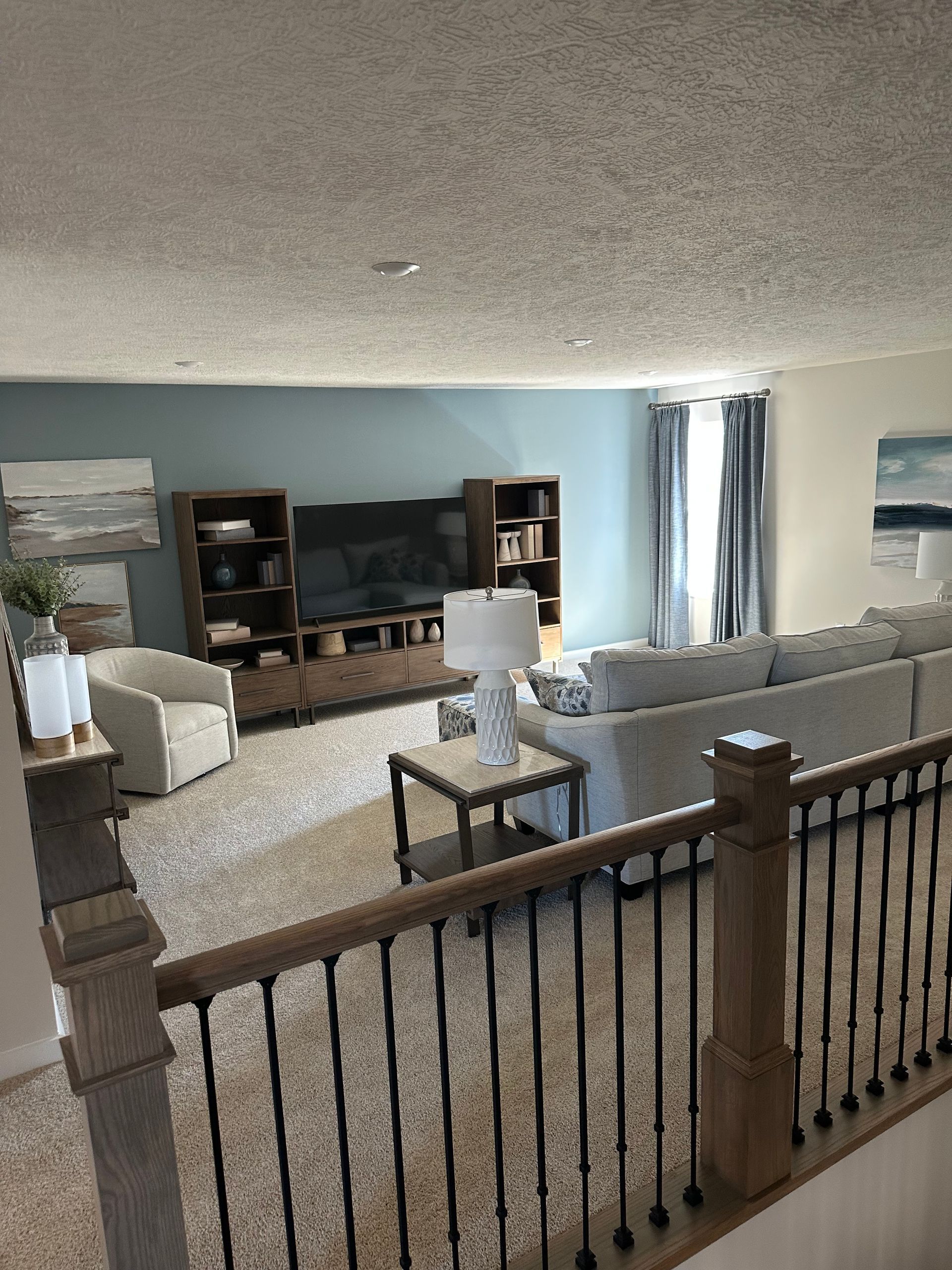 A living room with a couch , chairs , and a television.