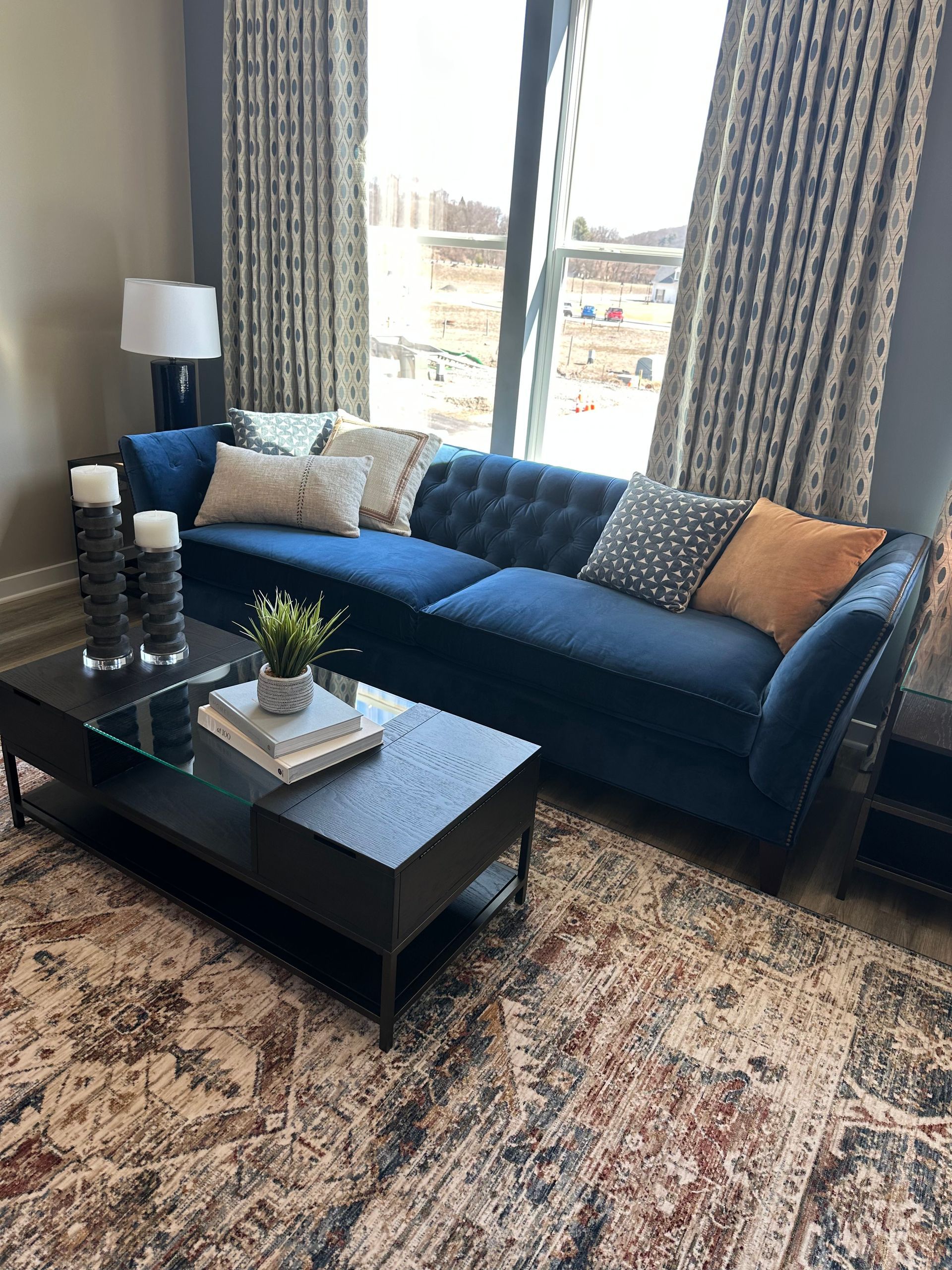 A living room with a blue couch and a coffee table.