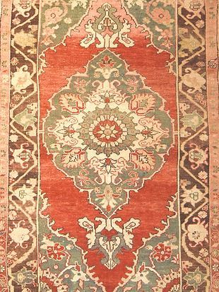 A close up of a rug with a floral pattern on it.
