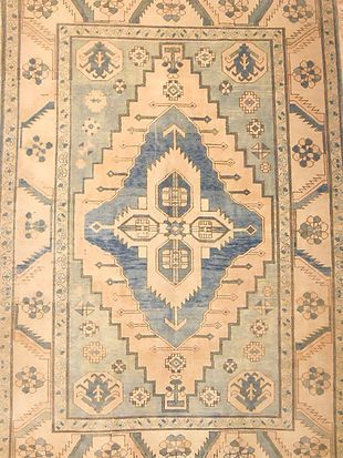 A rug with a blue and white pattern on it