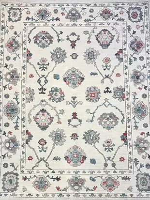 A white rug with a floral pattern on it