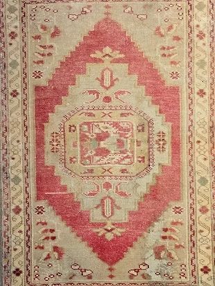 A rug with a geometric pattern on it is sitting on a table.