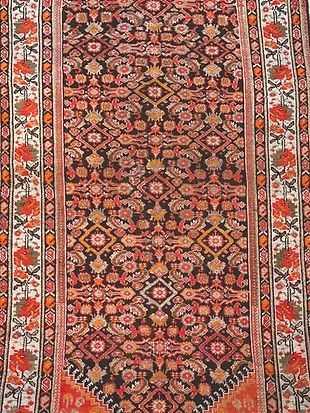 A close up of a rug with a floral pattern on it.