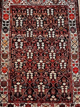 A close up of a rug with a floral pattern on it.