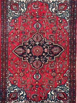A red rug with a blue and white pattern on it.
