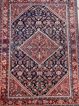 A close up of a rug with a diamond pattern on it.