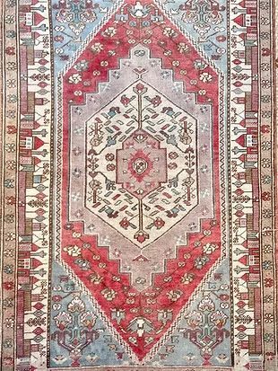 A rug with a red , white , and blue pattern on it.