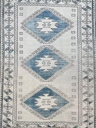A blue and white rug with a geometric pattern on it.