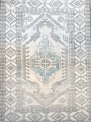 A close up of a rug with a geometric pattern on it.