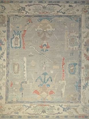 A close up of a rug with a floral pattern on it.