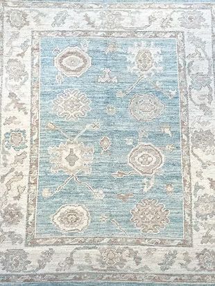 A blue and white rug with a floral pattern on it.