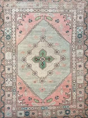 A rug with a floral pattern on it is sitting on a table.