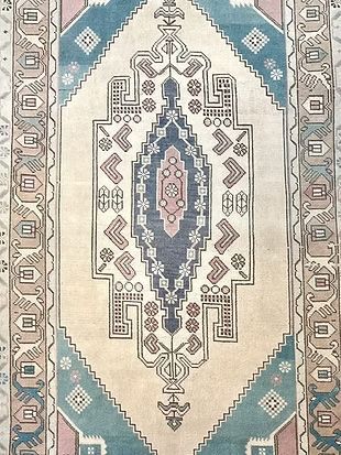A close up of a rug with a pattern on it.