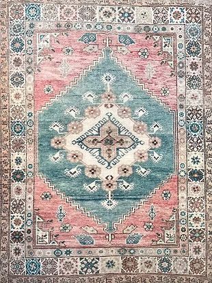 A close up of a rug with a floral pattern on it.