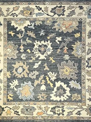 A black and white rug with a floral pattern on it.