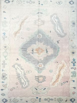 A white rug with a pattern on it is sitting on a table.