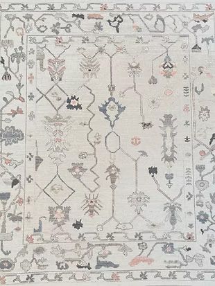 A white rug with a floral pattern on it.