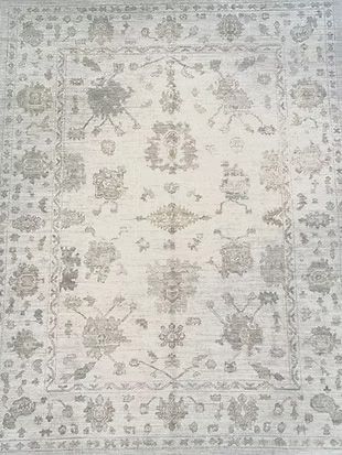 A white rug with a floral pattern on it.