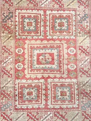 A close up of a rug with a pattern on it.