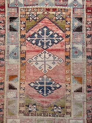 A close up of a rug with a geometric pattern on it.