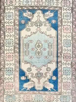 A blue and white rug with a floral pattern on it.