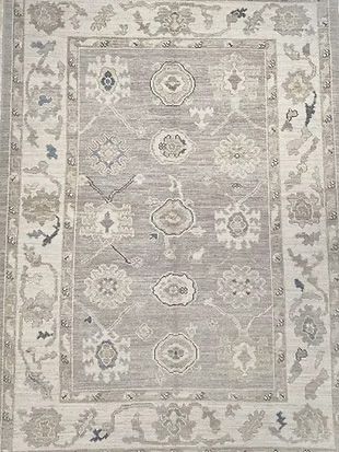 A rug with a floral pattern on it is sitting on a table.