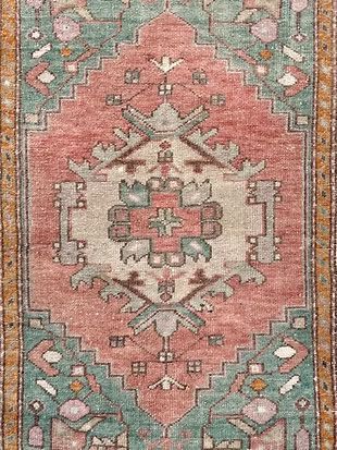 A close up of a rug with a floral pattern on it.