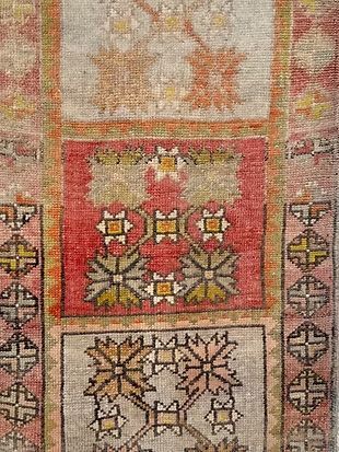 A close up of a rug with a floral pattern on it.