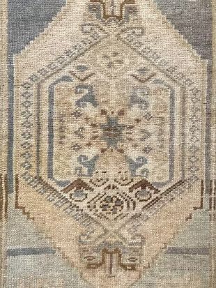 A close up of a rug with a pattern on it.