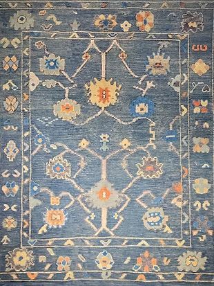 A blue rug with a floral pattern on it