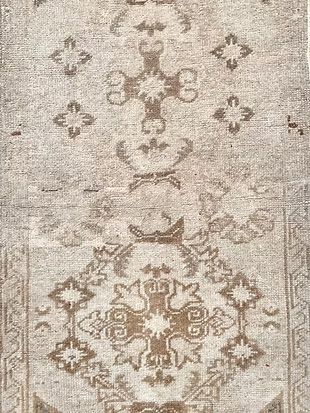 A close up of a rug with a floral pattern on it.